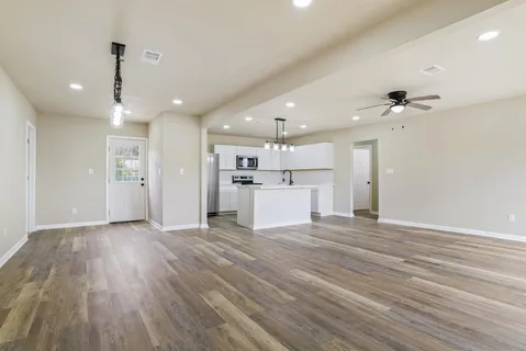 a view of a kitchen with a sink and a refrigerator