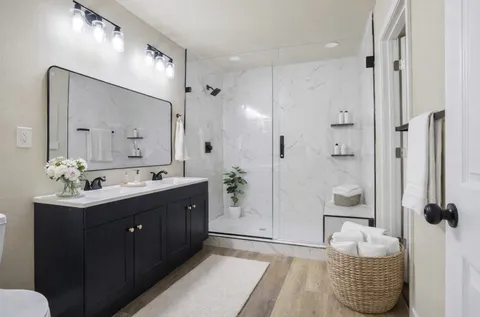 a bathroom with a sink double vanity and shower