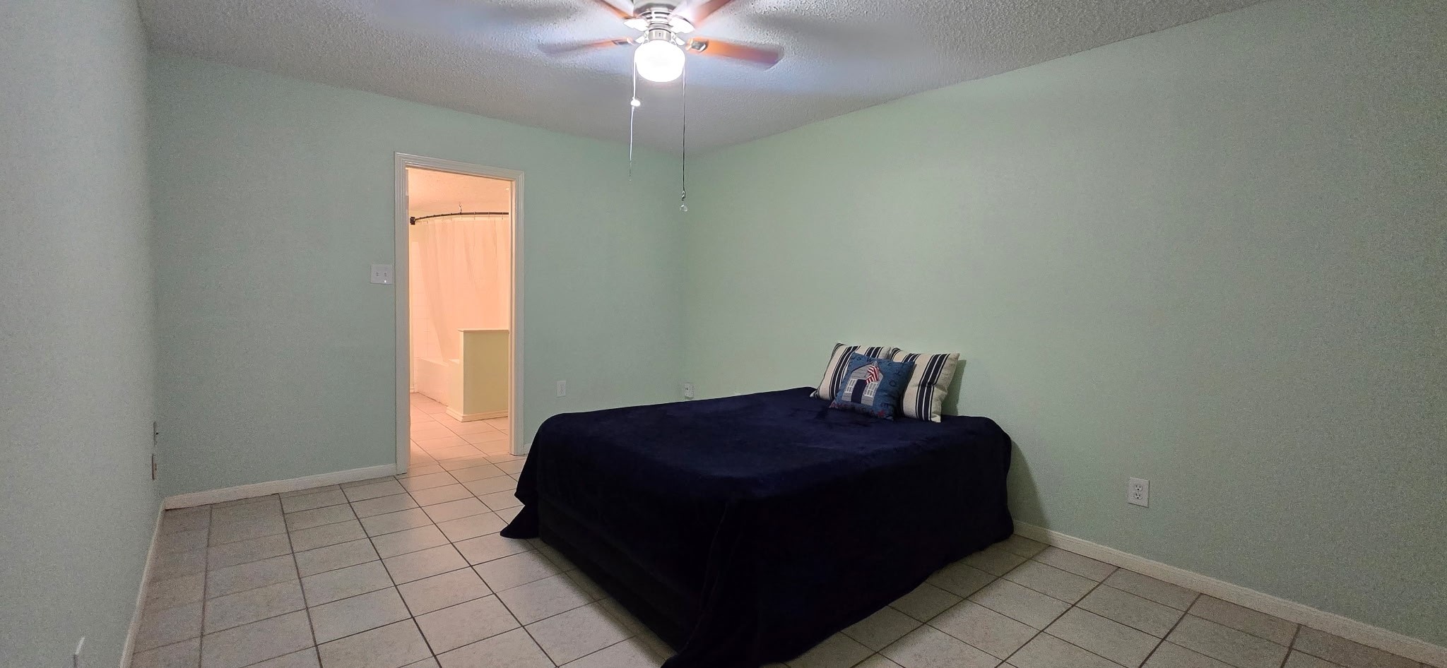 13715 Vickston Lane Houston, TX 77014 - Photo 7 of 11 a bedroom with a bed and a chandelier fan