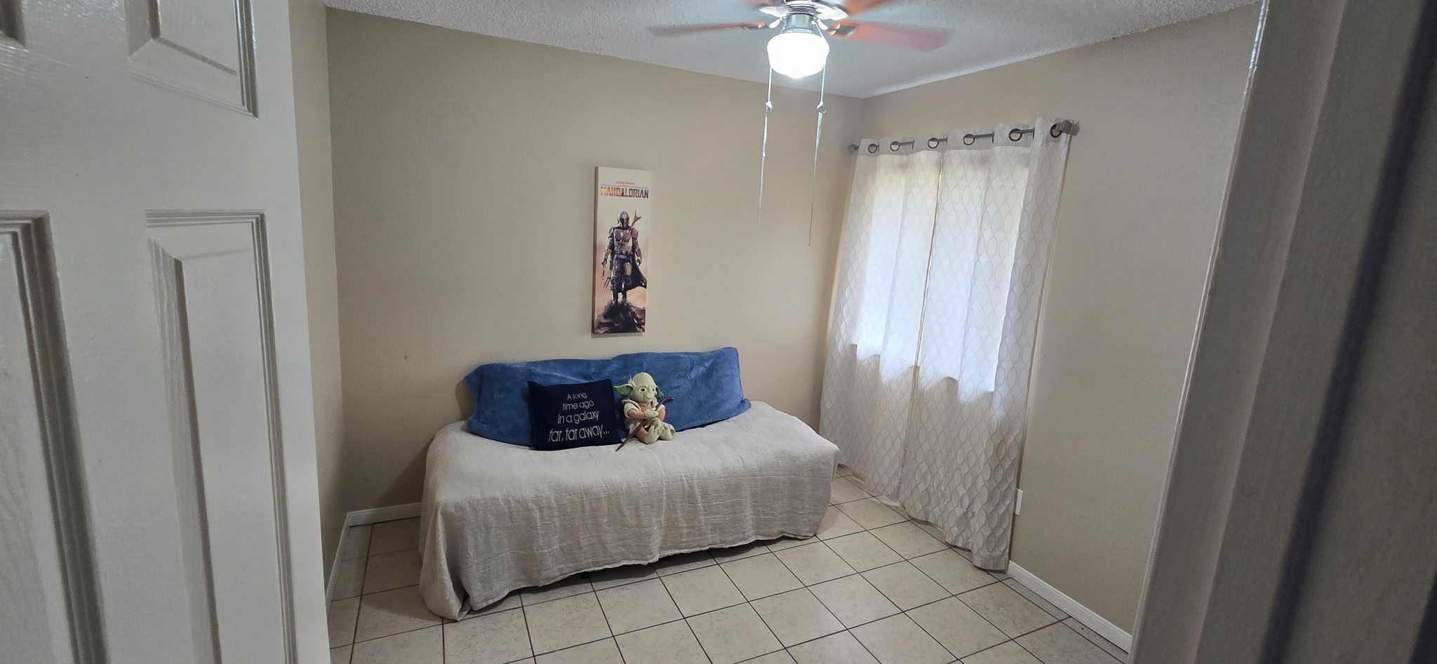 13715 Vickston Lane Houston, TX 77014 - Photo 8 of 11 a bedroom with a bed and a chandelier