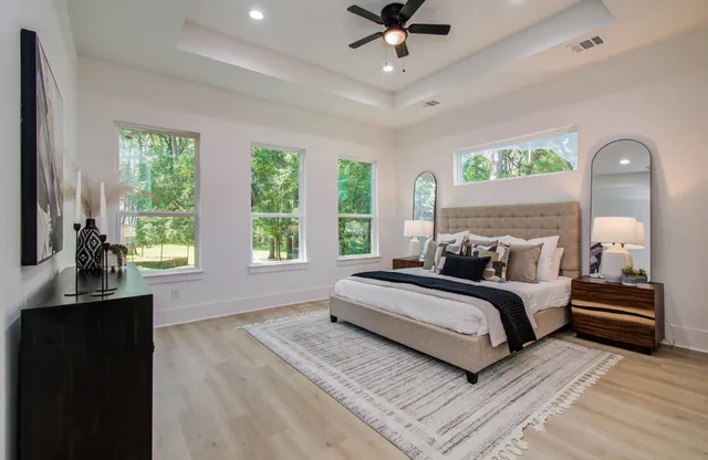 a bedroom with a bed and a chandelier