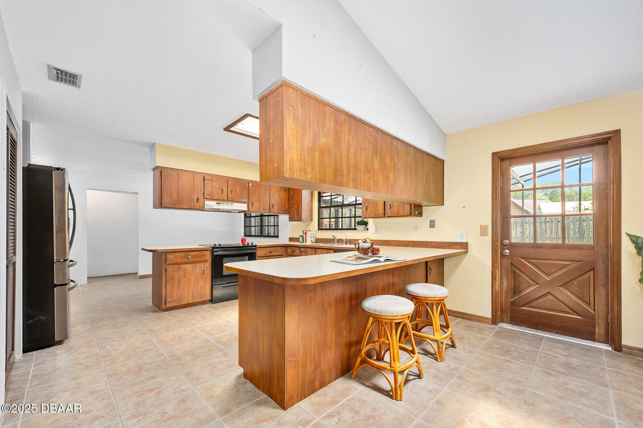 1 River Bluff Court Ormond Beach, FL 32174 - Photo 14 of 58 a kitchen with a stove a refrigerator and a dining table