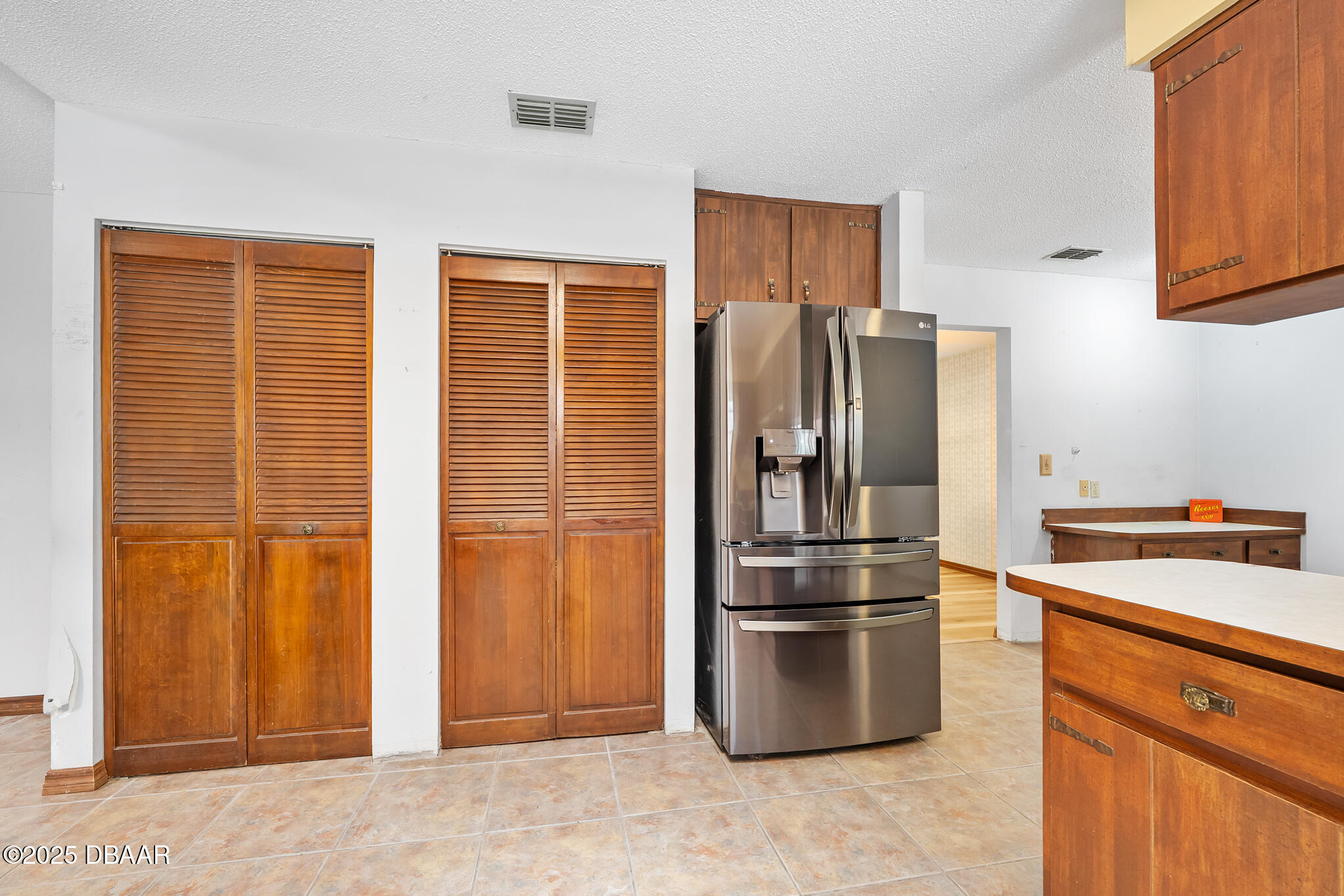 1 River Bluff Court Ormond Beach, FL 32174 - Photo 16 of 58 a kitchen with stainless steel appliances granite countertop a refrigerator and a stove