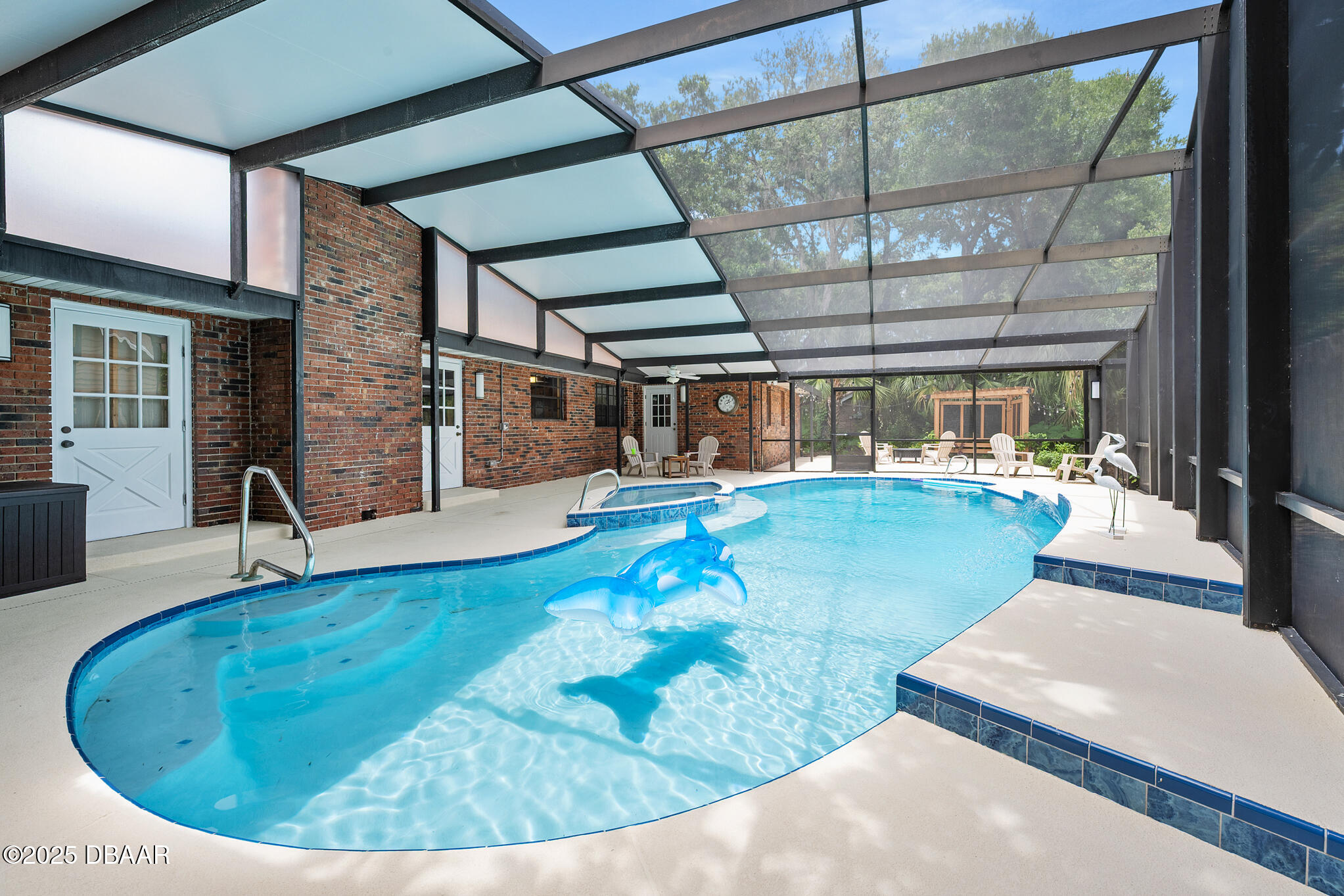 1 River Bluff Court Ormond Beach, FL 32174 - Photo 18 of 58 a swimming pool with outdoor seating