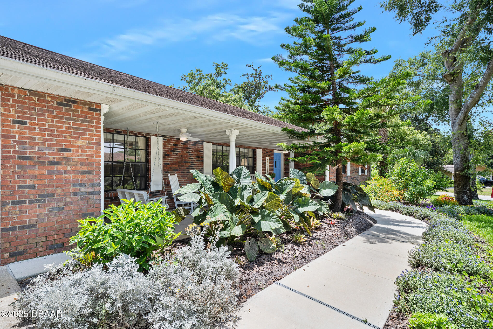 1 River Bluff Court Ormond Beach, FL 32174 - Photo 2 of 58 a front view of a house with a garden