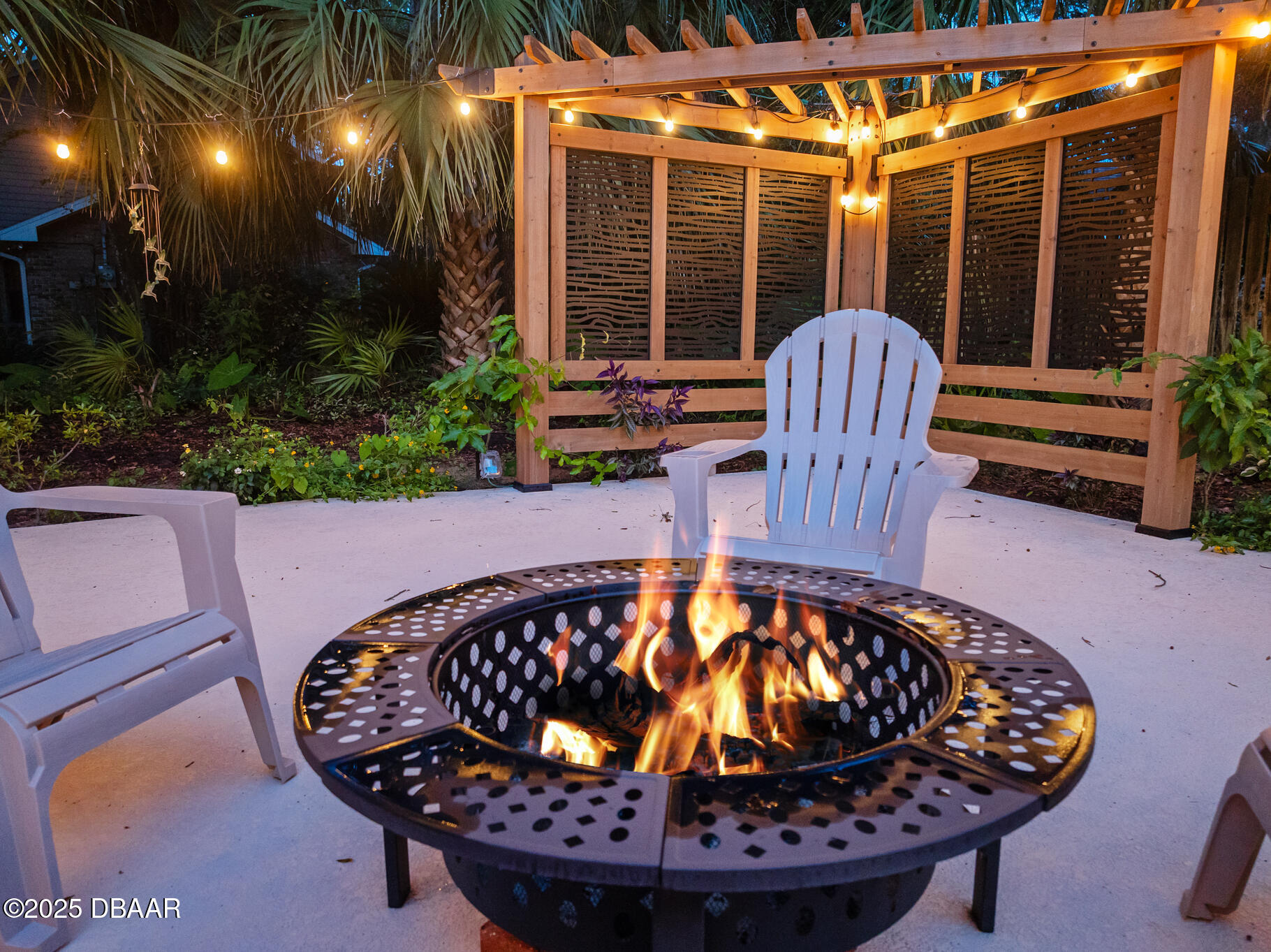 1 River Bluff Court Ormond Beach, FL 32174 - Photo 27 of 58 a view of a wooden chairs and fire pit in the patio