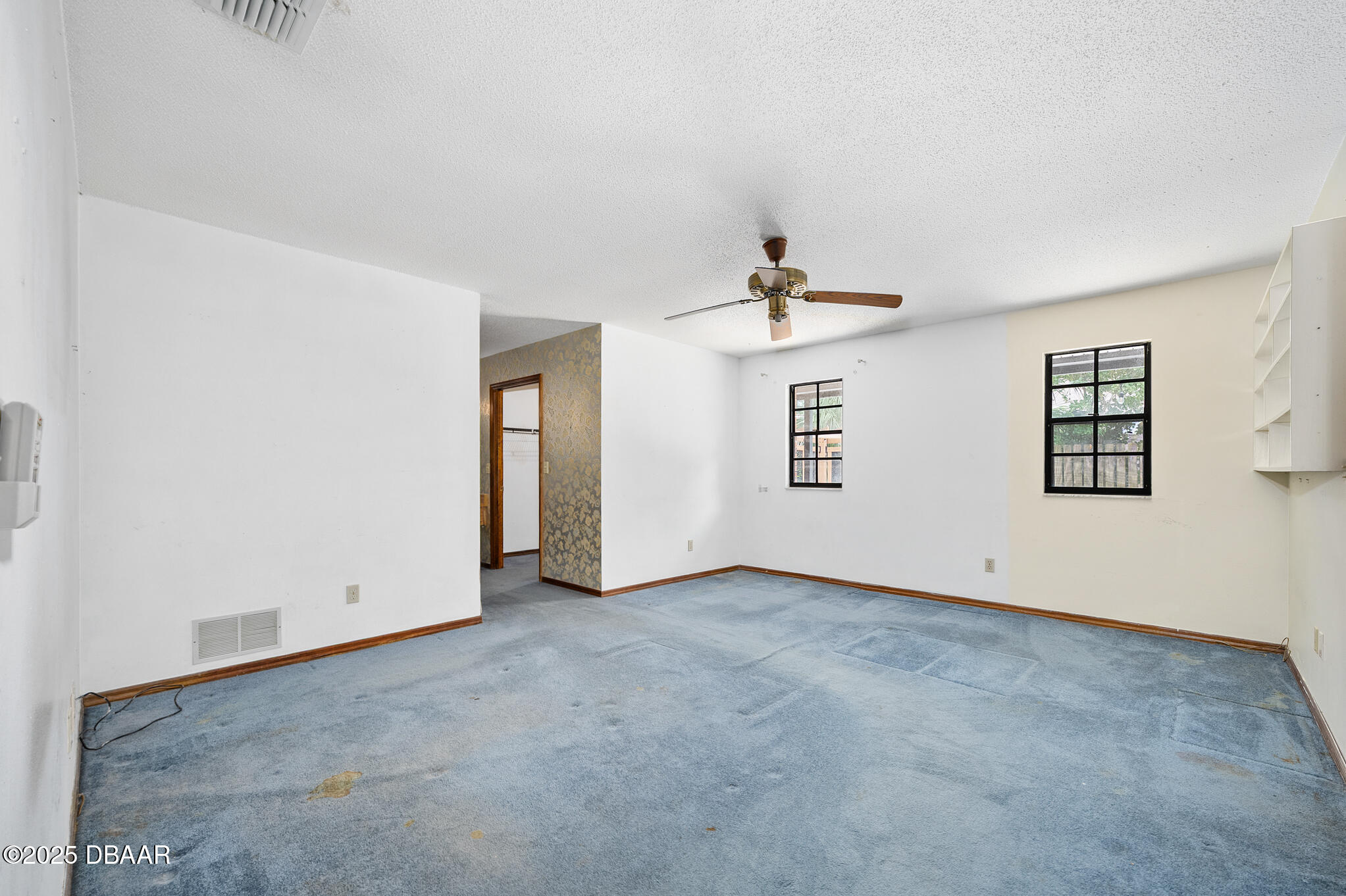 1 River Bluff Court Ormond Beach, FL 32174 - Photo 31 of 58 an empty room with windows and ceiling fan view