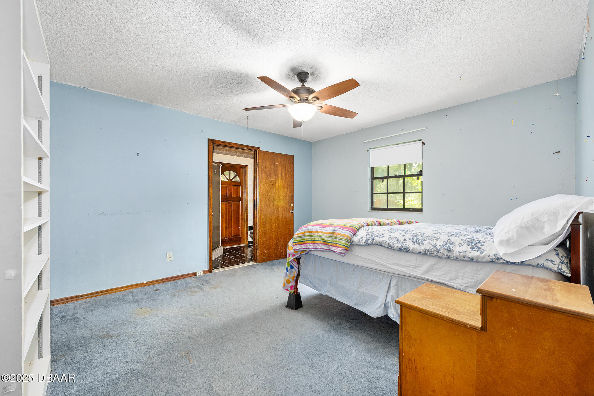 1 River Bluff Court Ormond Beach, FL 32174 - Photo 37 of 58 a bed sitting in a bedroom next to a window and a chandelier
