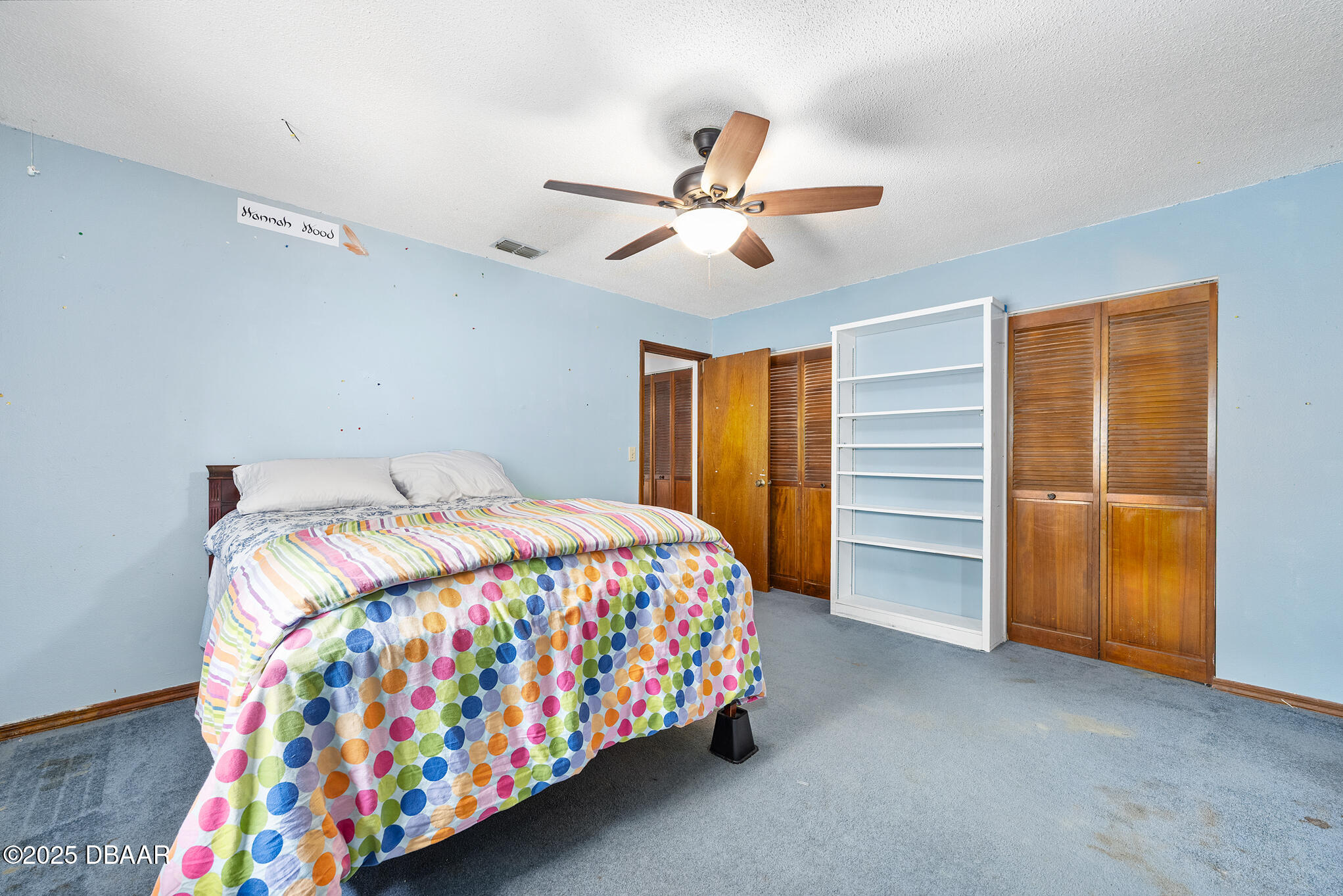 1 River Bluff Court Ormond Beach, FL 32174 - Photo 38 of 58 a bedroom with a bed and a chandelier