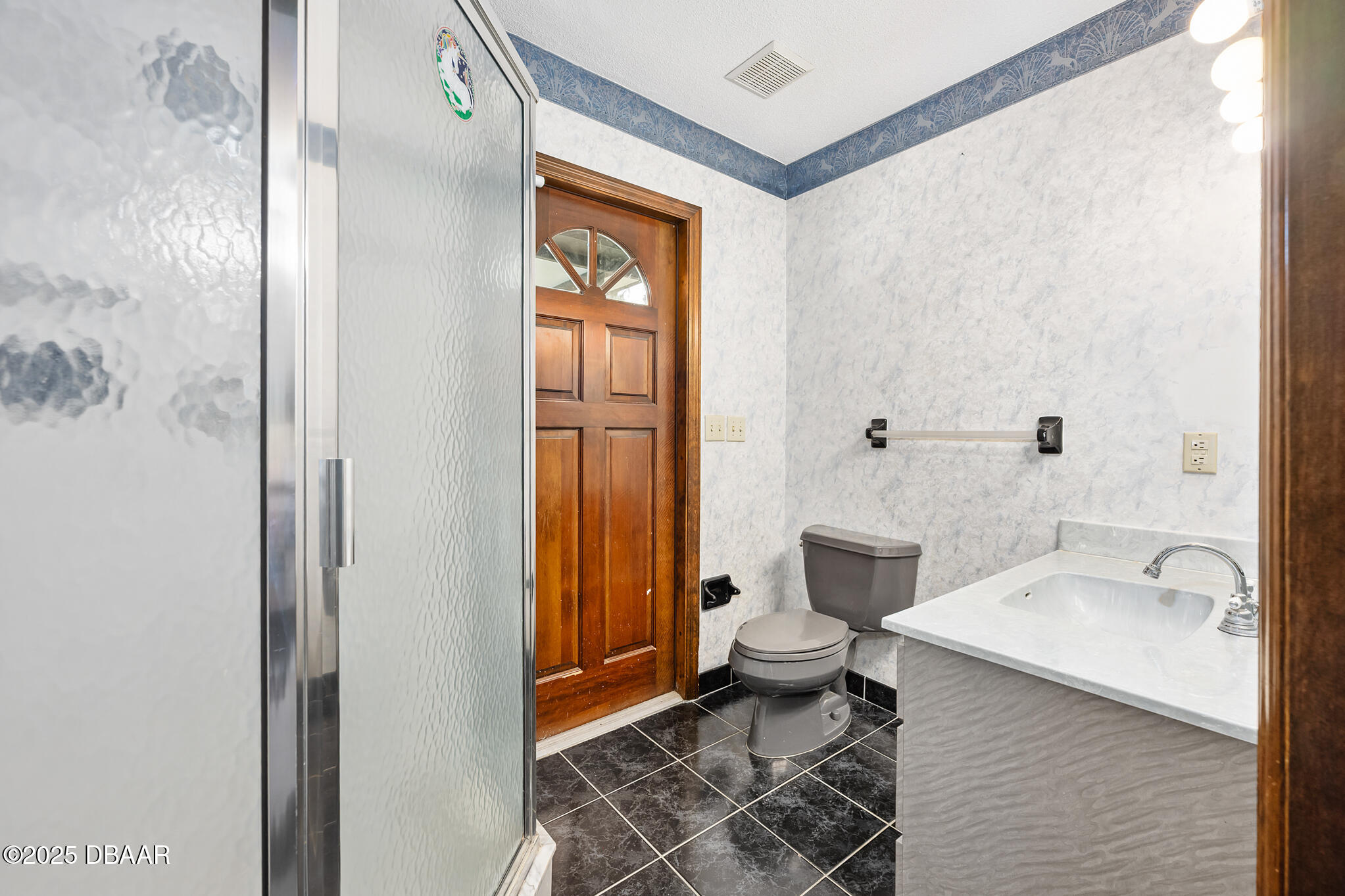 1 River Bluff Court Ormond Beach, FL 32174 - Photo 39 of 58 a bathroom with a toilet a sink and shower