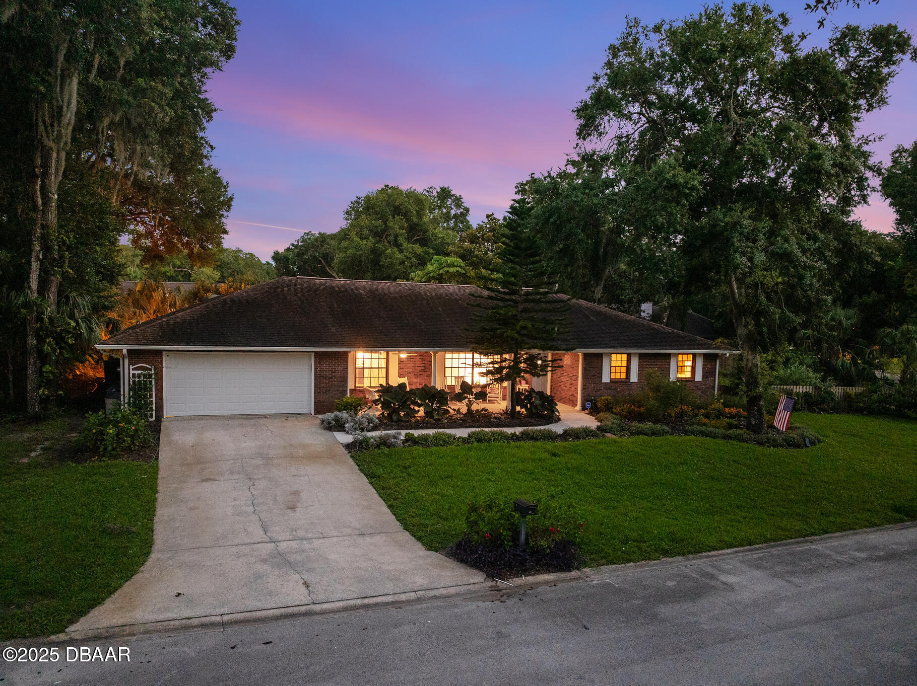1 River Bluff Court Ormond Beach, FL 32174 - Photo 47 of 58 a front view of a house with a yard and trees