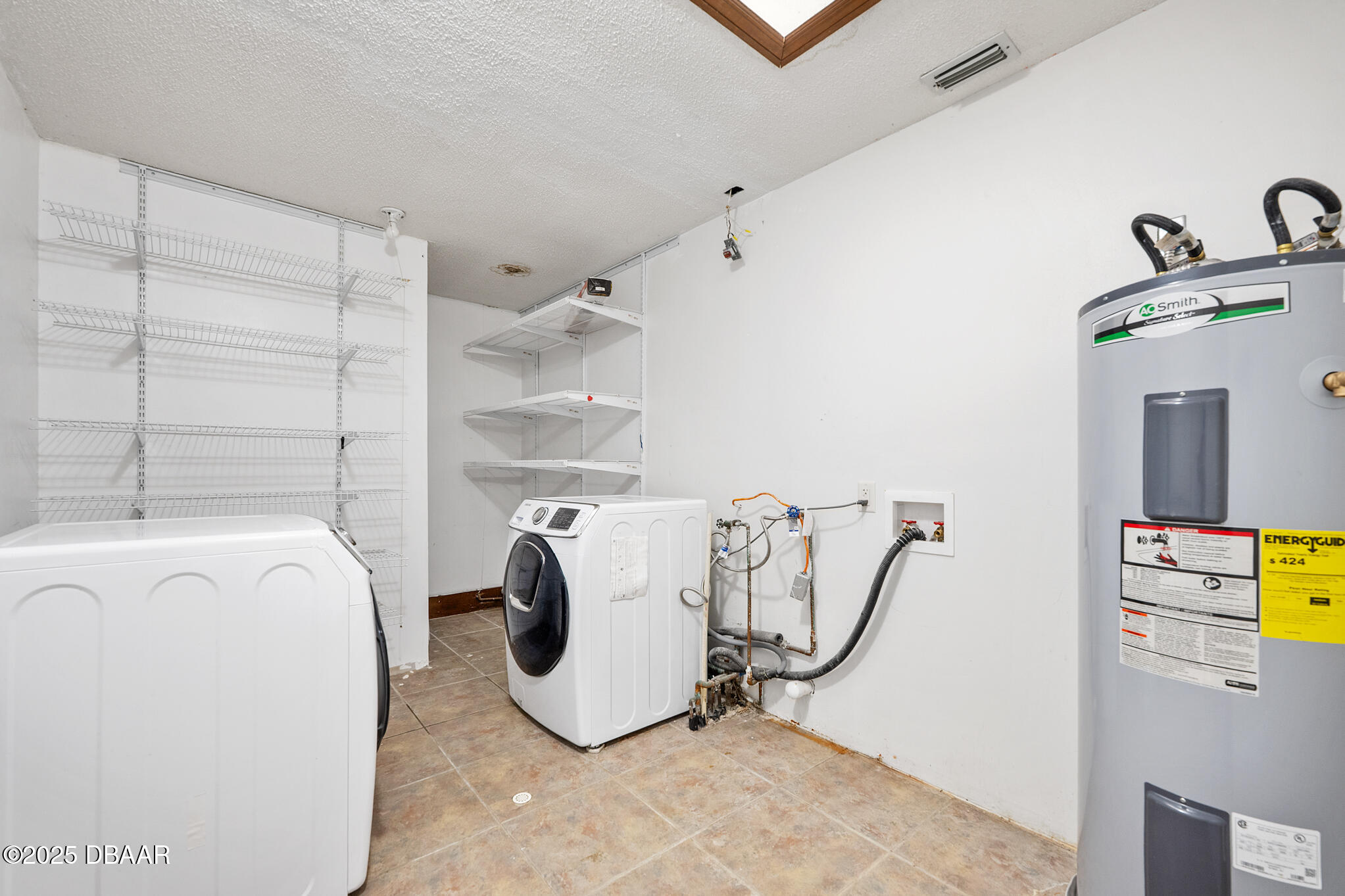 1 River Bluff Court Ormond Beach, FL 32174 - Photo 57 of 58 a view of a storage & utility room with washer and dryer
