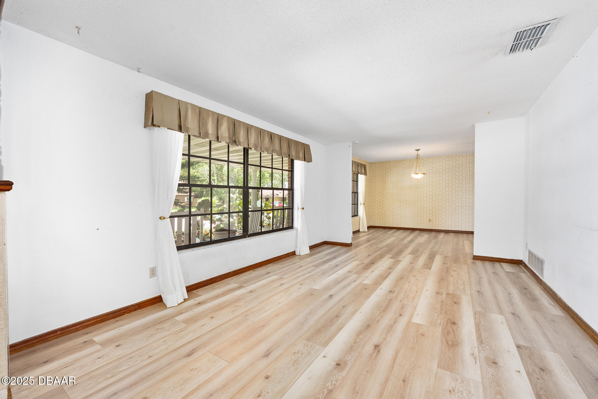 1 River Bluff Court Ormond Beach, FL 32174 - Photo 6 of 58 wooden floor in an empty room with a window