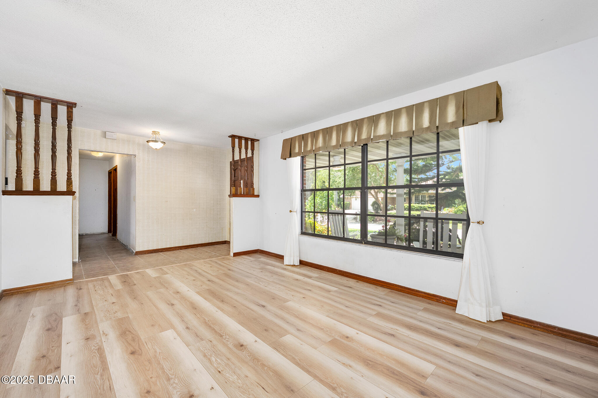 1 River Bluff Court Ormond Beach, FL 32174 - Photo 7 of 58 a view of empty room with wooden floor and fan