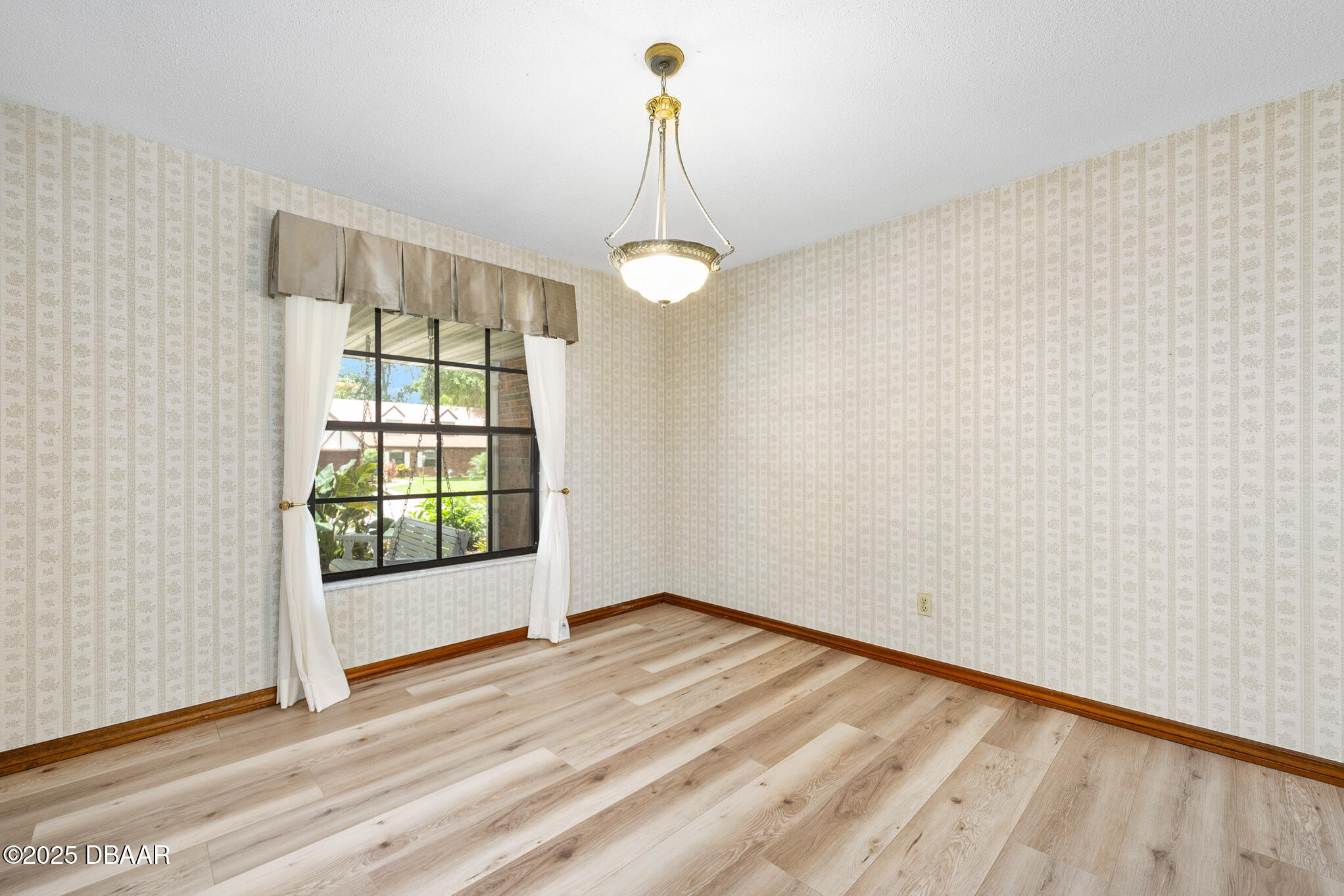 1 River Bluff Court Ormond Beach, FL 32174 - Photo 8 of 58 a view of empty room with wooden floor and fan