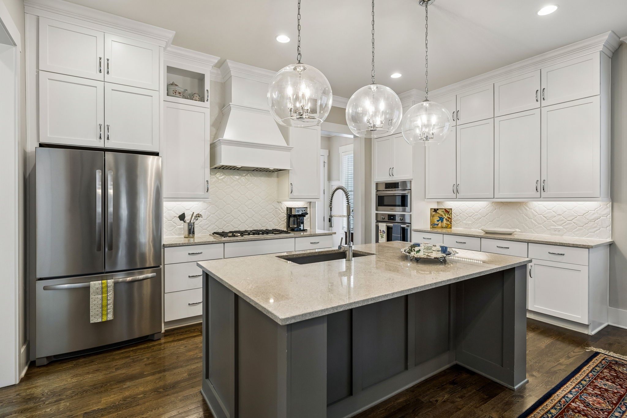 1085 Beckwith Street Franklin, TN 37064 - Photo 17 of 42 a kitchen with stainless steel appliances granite countertop a sink a stove a refrigerator and island with wooden floor