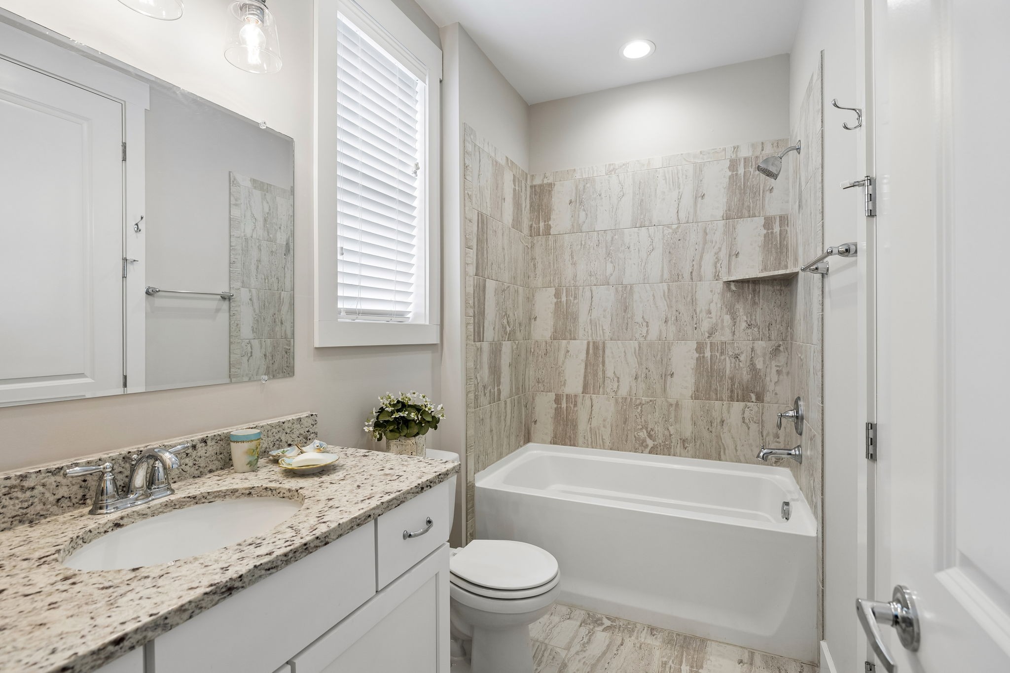 1085 Beckwith Street Franklin, TN 37064 - Photo 33 of 42 a bathroom with a granite countertop toilet a sink and a bathtub