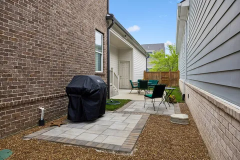 a view of a patio with a table and chairs in patio