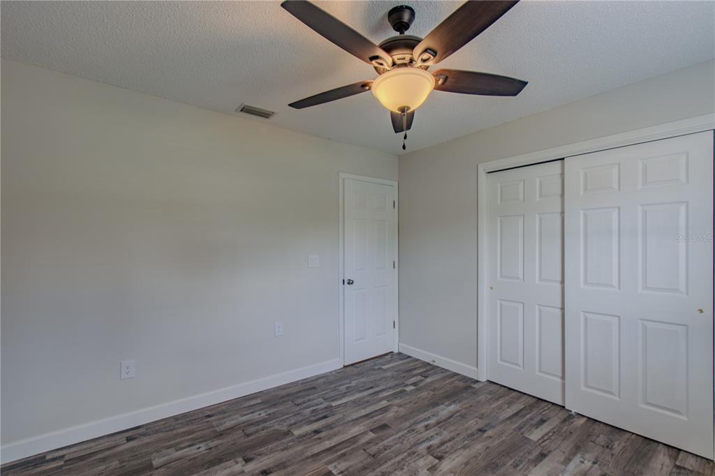 24024 Deer Road Astor, FL 32102 - Photo 12 of 22 an empty room with a ceiling fan