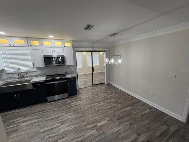 a kitchen with granite countertop a stove and a refrigerator