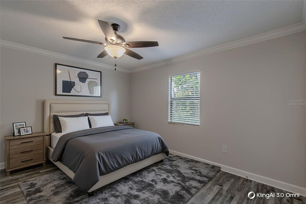 24024 Deer Road Astor, FL 32102 - Photo 14 of 31 a bedroom with a bed and a window