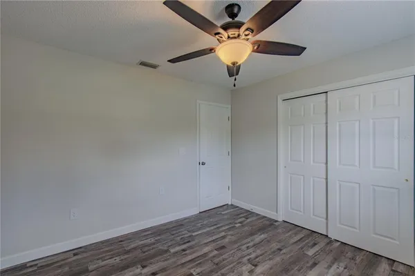an empty room with a ceiling fan