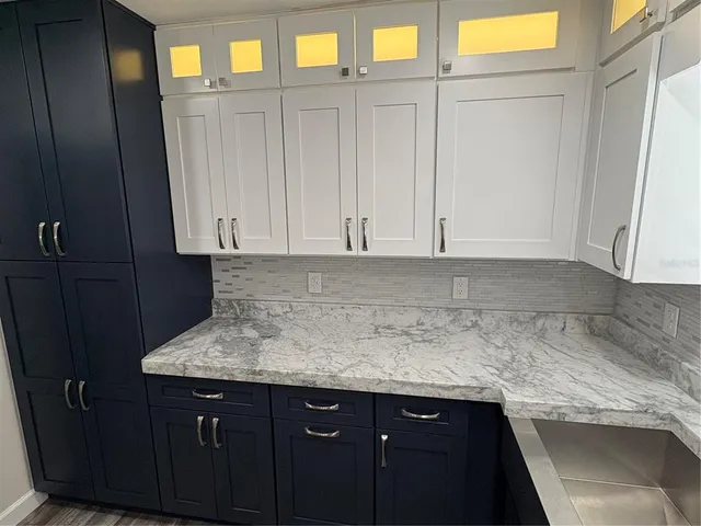 a kitchen with a sink and cabinets