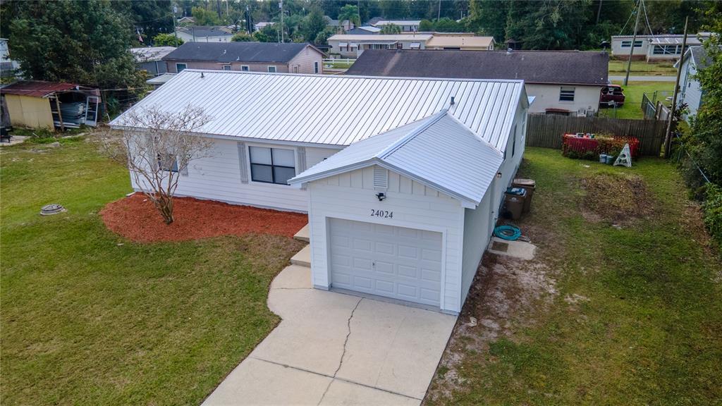 24024 Deer Road Astor, FL 32102 - Photo 2 of 22 a view of a house with a yard porch and sitting area