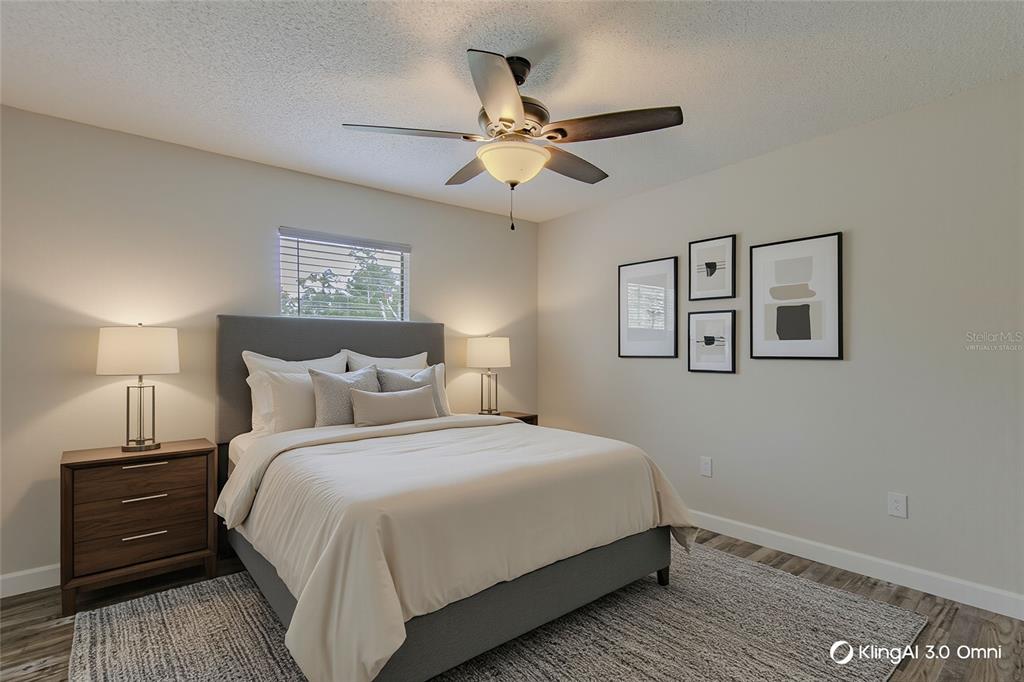 24024 Deer Road Astor, FL 32102 - Photo 22 of 31 a bedroom with a bed and a chandelier