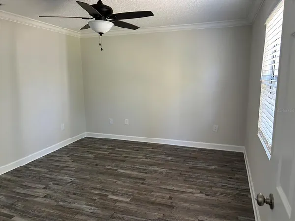 a bathroom with a granite countertop toilet sink and mirror
