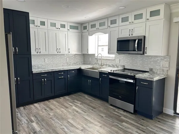 a kitchen with a sink and a refrigerator