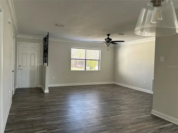 a large kitchen with kitchen island granite countertop wooden floors and stainless steel appliances