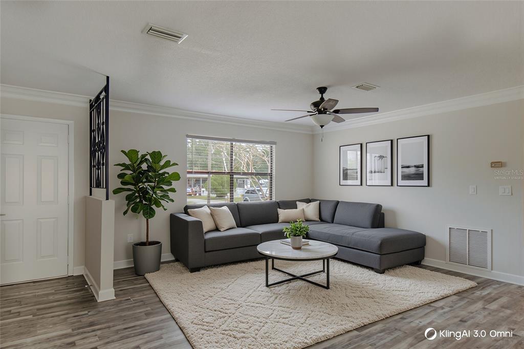 24024 Deer Road Astor, FL 32102 - Photo 5 of 31 a living room with furniture potted plant and a window
