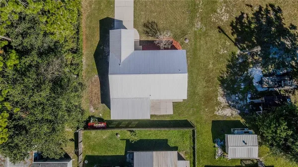 an aerial view of a house with a yard