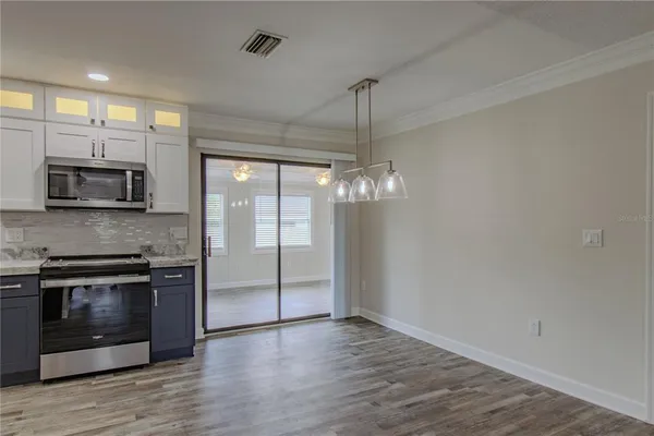 a view of a kitchen with a stove cabinets and wooden floor