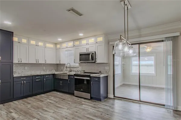 a kitchen with stainless steel appliances granite countertop a sink and a refrigerator