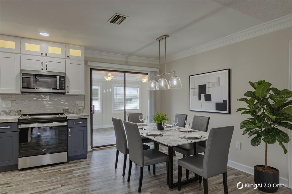 24024 Deer Road Astor, FL 32102 - Photo 9 of 31 a view of a dining room with furniture and wooden floor