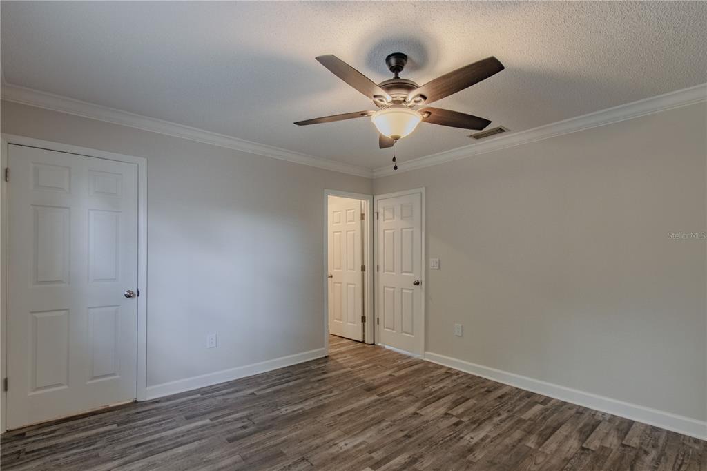 24024 Deer Road Astor, FL 32102 - Photo 9 of 22 a view of an empty room with wooden floor