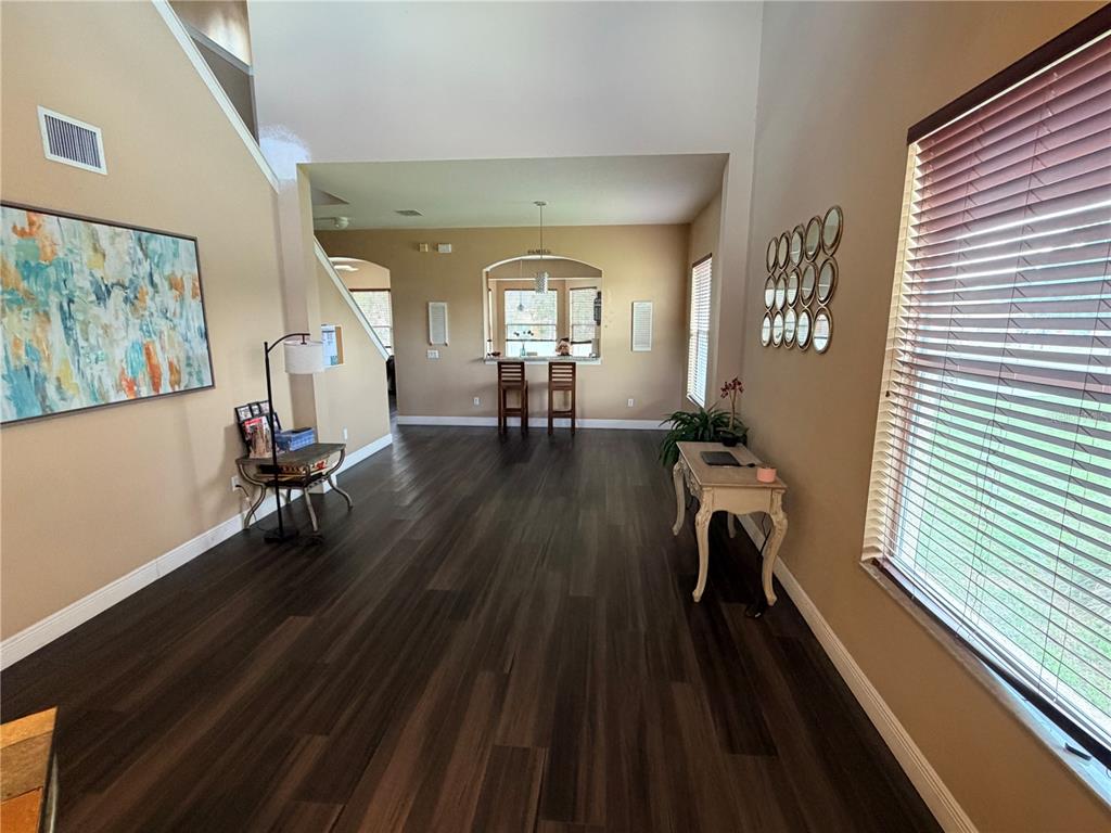 13250 Mandalay Place Spring Hill, FL 34609 - Photo 4 of 28 a view of a room with gym equipment on wooden floor