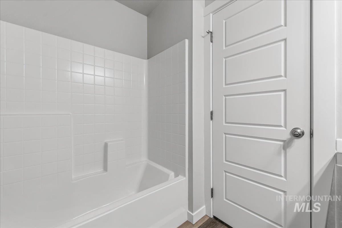 3091 S Green Boise, ID 83709 - Photo 20 of 27 White fiberglass tub and shower combination with integrated shelving