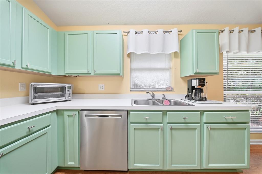 5856 Count Turf Lane Wesley Chapel, FL 33544 - Photo 13 of 57 a kitchen with a sink cabinets and a window