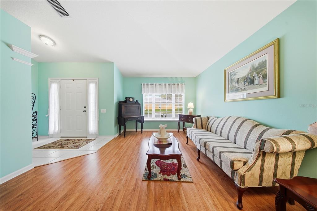 5856 Count Turf Lane Wesley Chapel, FL 33544 - Photo 14 of 57 a living room with furniture and wooden floor