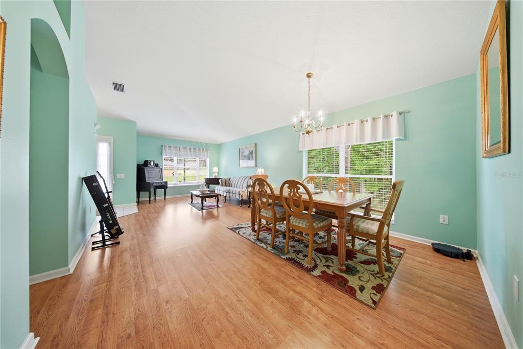 5856 Count Turf Lane Wesley Chapel, FL 33544 - Photo 15 of 57 a living room with furniture and a chandelier