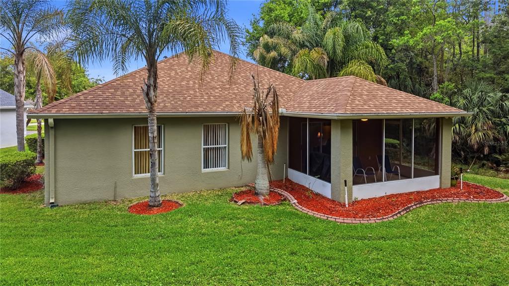 5856 Count Turf Lane Wesley Chapel, FL 33544 - Photo 22 of 57 a view of a house with a yard and potted plants