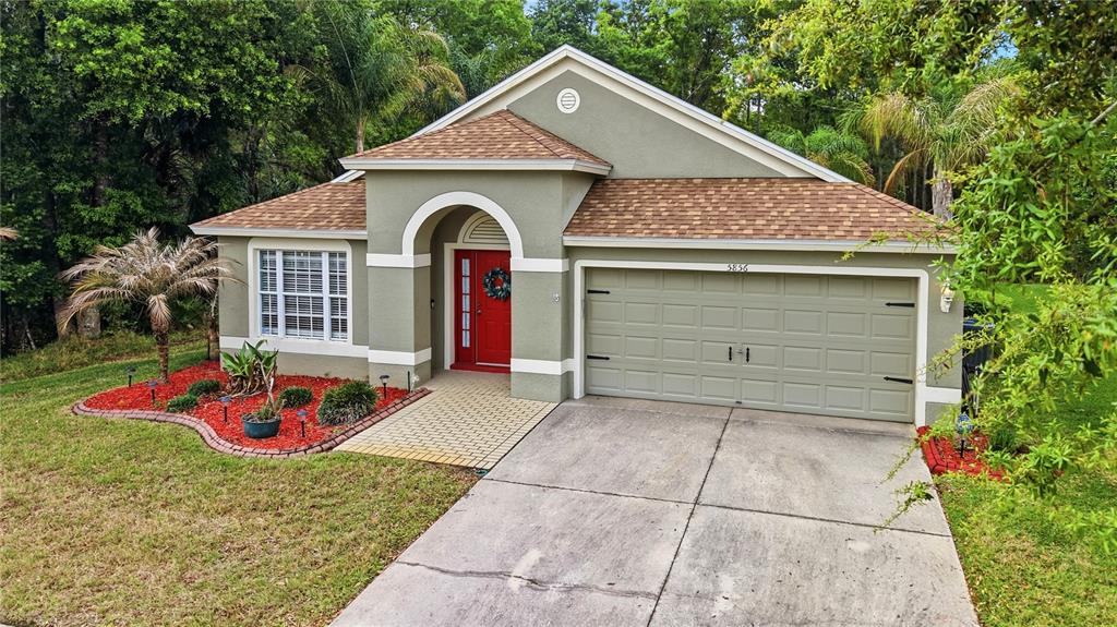 5856 Count Turf Lane Wesley Chapel, FL 33544 - Photo 25 of 57 a front view of a house with porch