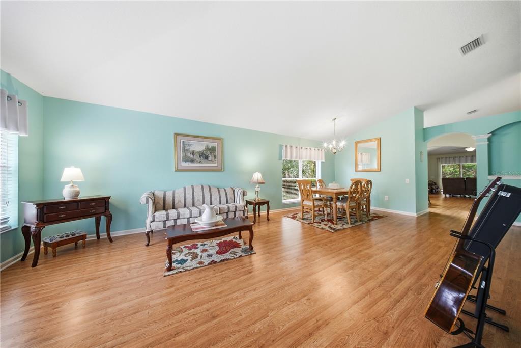 5856 Count Turf Lane Wesley Chapel, FL 33544 - Photo 3 of 57 a living room with furniture and a wooden floor