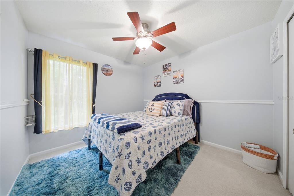 5856 Count Turf Lane Wesley Chapel, FL 33544 - Photo 34 of 57 a bedroom with a bed and a ceiling fan