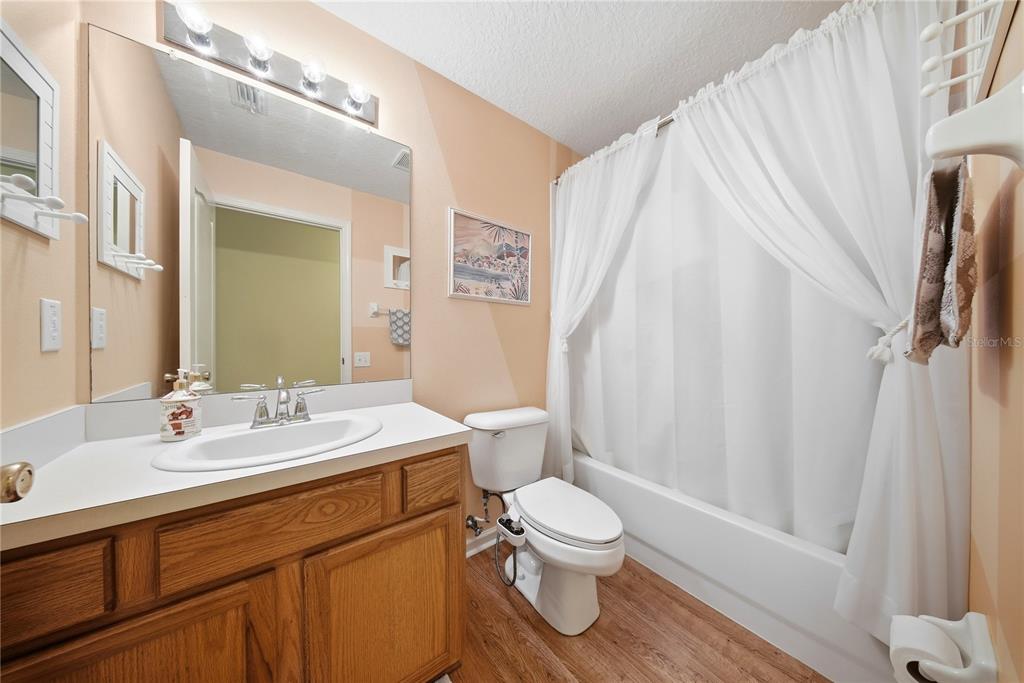 5856 Count Turf Lane Wesley Chapel, FL 33544 - Photo 38 of 57 a bathroom with a sink a toilet and a mirror