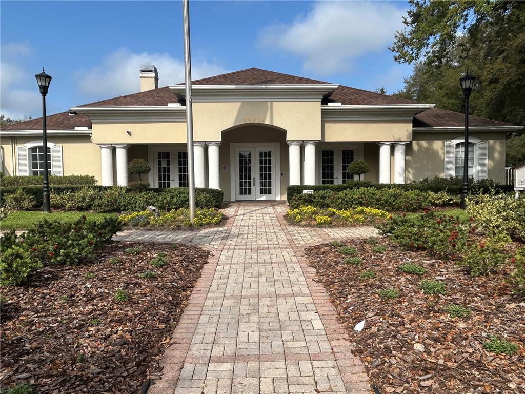 5856 Count Turf Lane Wesley Chapel, FL 33544 - Photo 45 of 57 a front view of a house with garden
