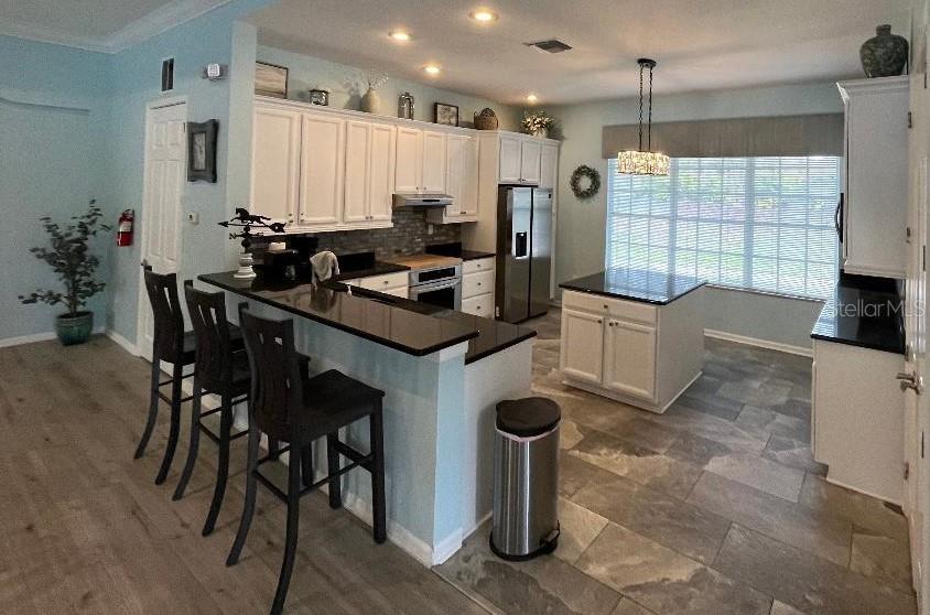 5856 Count Turf Lane Wesley Chapel, FL 33544 - Photo 46 of 57 a kitchen that has a table and chairs in it